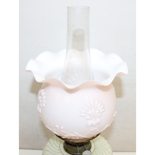 236 - An antique oil lamp with moulded milk glass shade, a moulded and painted milk glass reservoir, and a... 