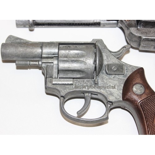 1407 - Replica weapons: Colt .45 Peacemaker revolver, Colt .36 Navy revolver and a Die Cast Interpol Specia... 