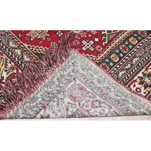 209 - A good quality red ground modern rug, no label, approx 225cm x 140cm