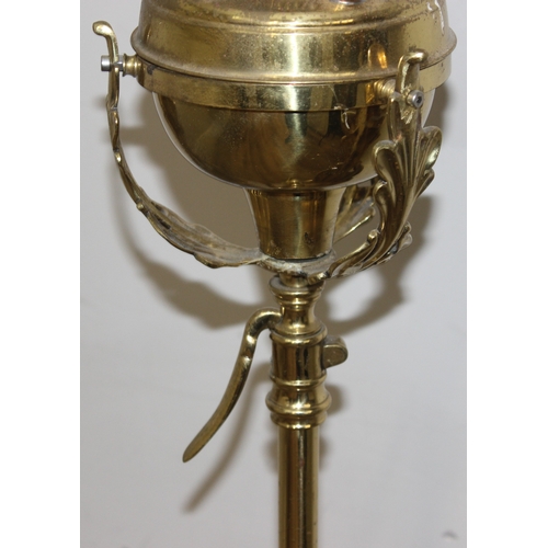 240 - An antique oil standard lamp with milk glass shade, a brass reservoir, and a telescopic brass base, ... 