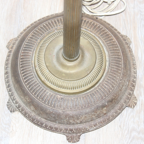 243 - A vintage brass standard lamp with shade, the lamp formed as a reeded pillar, approx 185cm tall