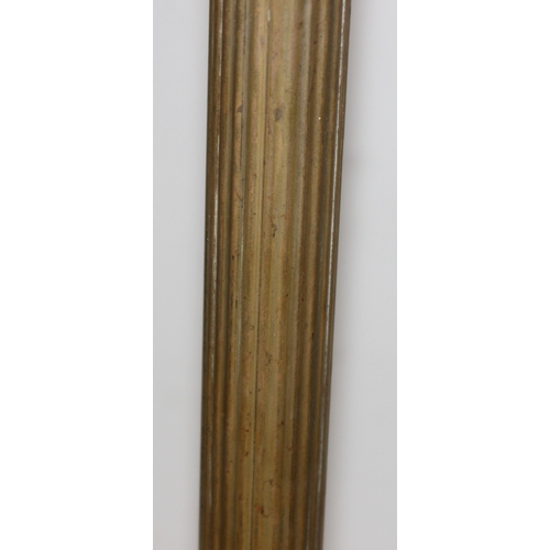 243 - A vintage brass standard lamp with shade, the lamp formed as a reeded pillar, approx 185cm tall