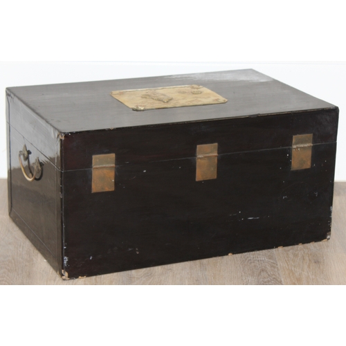 283 - A vintage Oriental black lacquered box with embossed brass fittings, approx 62cm wide x 40cm deep x ... 