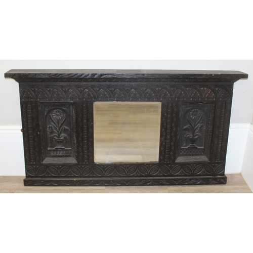 366 - A 19th century Gothic Revival carved oak over-mantel or wall mirror, a projecting cornice over friez... 