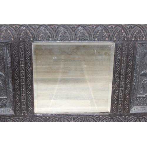 366 - A 19th century Gothic Revival carved oak over-mantel or wall mirror, a projecting cornice over friez... 