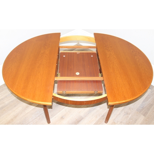 114 - A retro Macintosh Furniture extending circular dining table, label to inside leaf, approx 122cm in d... 