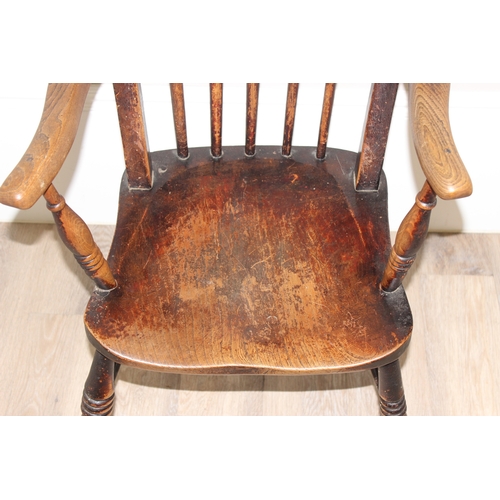 63 - An antique elm seated farmhouse stickback Windsor chair, approx 55cm wide x 99cm tall