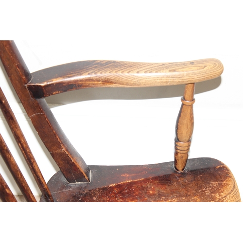 63 - An antique elm seated farmhouse stickback Windsor chair, approx 55cm wide x 99cm tall