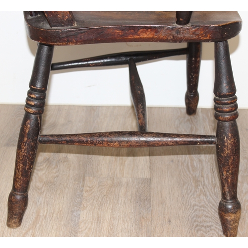 63 - An antique elm seated farmhouse stickback Windsor chair, approx 55cm wide x 99cm tall