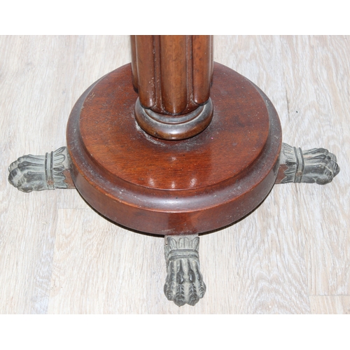 142 - An antique mahogany jardinière stand formed as a reeded pillar with lion paw feet, with an associate... 