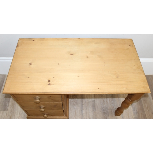 79 - A modern stripped pine desk with 3 drawers, approx 110cm wide x 57cm deep x 77cm tall