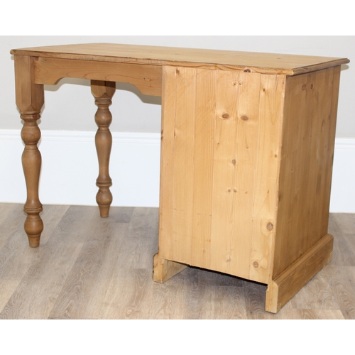 79 - A modern stripped pine desk with 3 drawers, approx 110cm wide x 57cm deep x 77cm tall