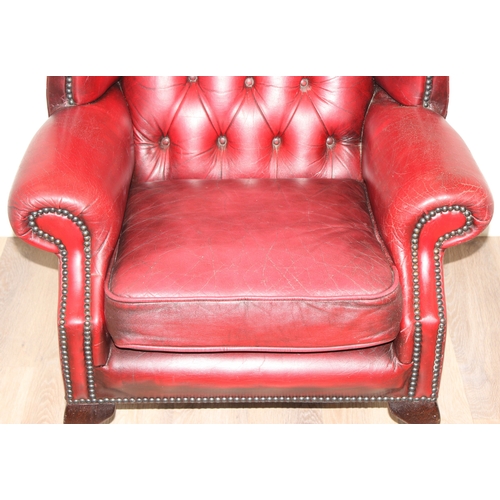 80 - An Ox-Blood red leather Chesterfield style wingback armchair by Wyvern, approx 82cm wide x 100cm tal... 