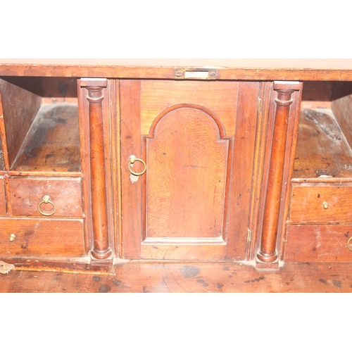 75 - A Georgian mahogany bureau with fitted interior, 4 long drawers with brass drop handles and bracket ... 