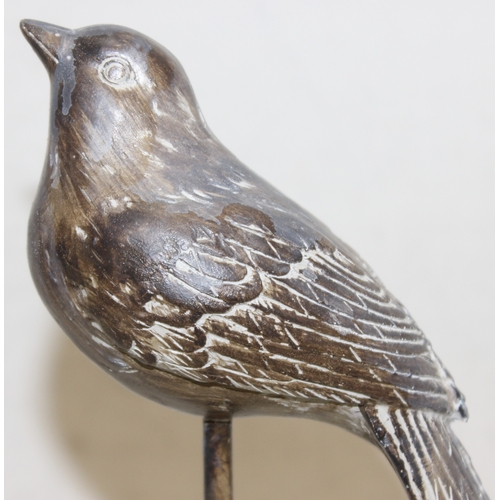 1650 - A highly decorative carved wooden parrot and a pair of long tailed warblers on stands, parrot approx... 