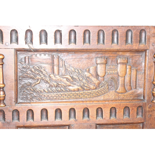 34 - An impressive antique oak coffer with carved details, the body of unusual large proportions with peg... 