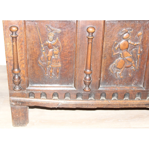 34 - An impressive antique oak coffer with carved details, the body of unusual large proportions with peg... 