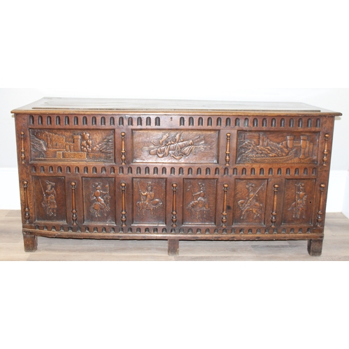 34 - An impressive antique oak coffer with carved details, the body of unusual large proportions with peg... 