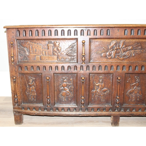 34 - An impressive antique oak coffer with carved details, the body of unusual large proportions with peg... 