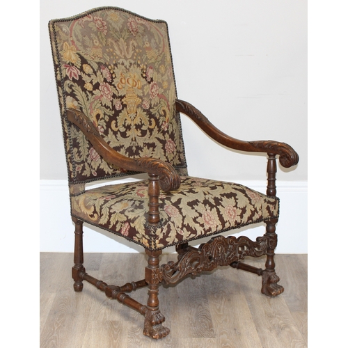 31 - A Louis 14th style armchair with exposed carved walnut frame, decorated with acanthus leaves, the fr... 