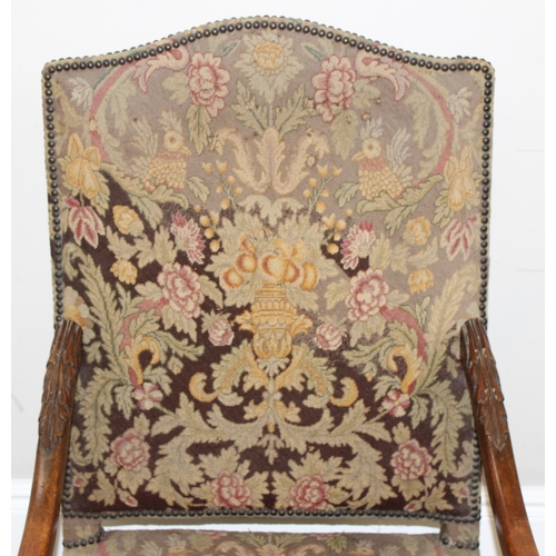 31 - A Louis 14th style armchair with exposed carved walnut frame, decorated with acanthus leaves, the fr... 