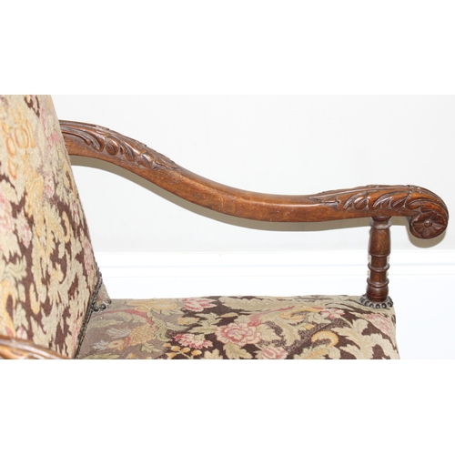 31 - A Louis 14th style armchair with exposed carved walnut frame, decorated with acanthus leaves, the fr... 