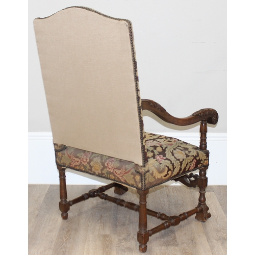 31 - A Louis 14th style armchair with exposed carved walnut frame, decorated with acanthus leaves, the fr... 