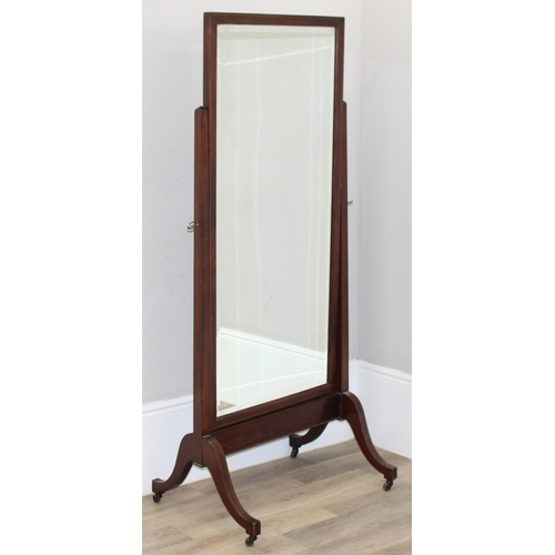 33 - A large and impressive Edwardian Sheraton Revival cheval mirror on stand, the base with brass castor... 