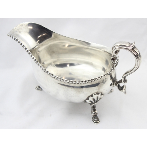 1064 - A heavy gauge Georgian style silver sauce or gravy boat with gadrooned border, London 1918 by Thomas... 