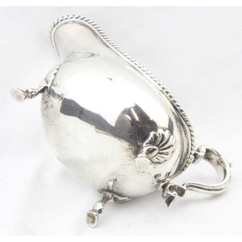 1064 - A heavy gauge Georgian style silver sauce or gravy boat with gadrooned border, London 1918 by Thomas... 