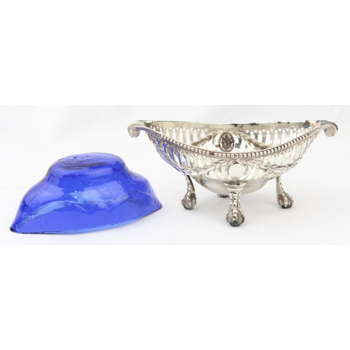 1072 - A George III period silver salt with pierced body, scroll ends and ball and claw feet, blue glass li... 