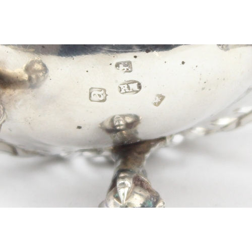 1072 - A George III period silver salt with pierced body, scroll ends and ball and claw feet, blue glass li... 