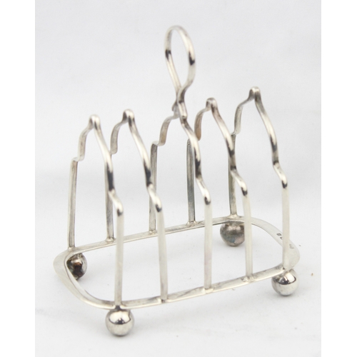 1076 - A vintage silver 4 slice toast rack, Birmingham 1931 by Alexander Clark & Co Ltd, approx 10cm wide, ... 