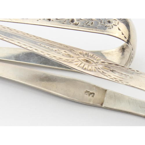 1083 - 2 pairs of antique silver sugar tongs, both with bright cut decoration, one by Hester Bateman with o... 