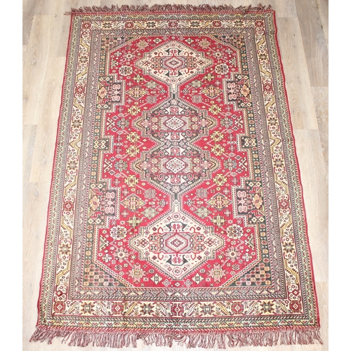 209 - A good quality red ground modern rug, no label, approx 225cm x 140cm