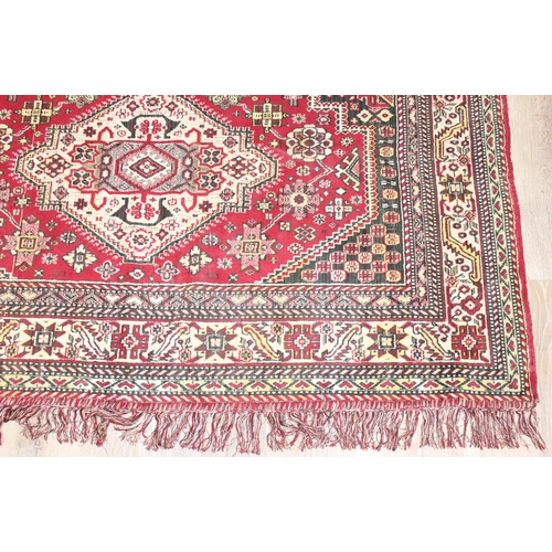 209 - A good quality red ground modern rug, no label, approx 225cm x 140cm