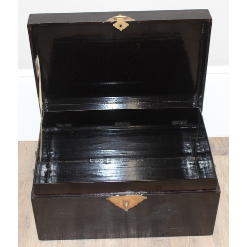 283 - A vintage Oriental black lacquered box with embossed brass fittings, approx 62cm wide x 40cm deep x ... 