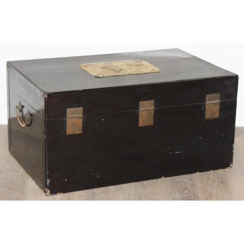 283 - A vintage Oriental black lacquered box with embossed brass fittings, approx 62cm wide x 40cm deep x ... 