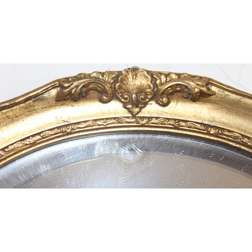 371 - 2 vintage oval shaped gilt framed wall mirrors of smaller proportions, the largest approx 31cm x 26c... 