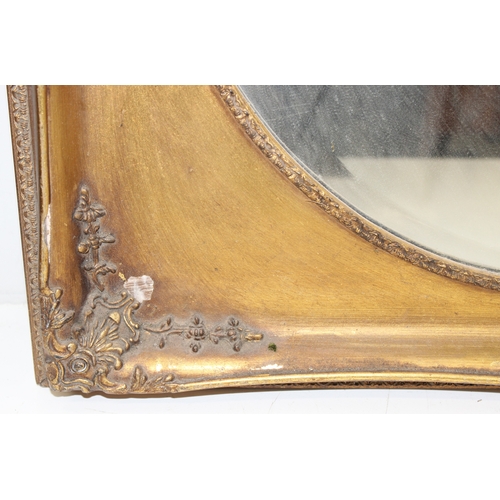 372 - A vintage gilt framed mirror with bevelled oval glass panel, approx 73cm x 63cm