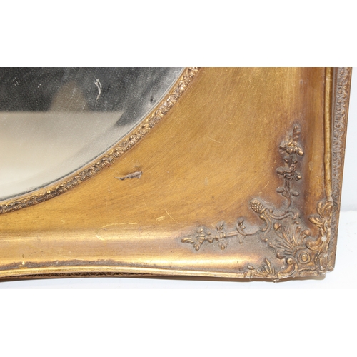 372 - A vintage gilt framed mirror with bevelled oval glass panel, approx 73cm x 63cm