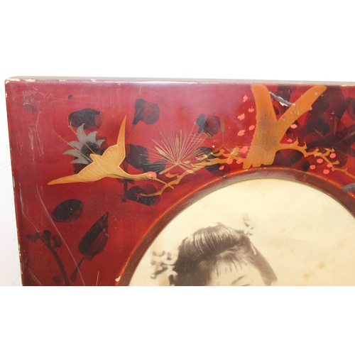 379 - Pair of early 20th century Japanese red lacquered photo frames with partially hand-coloured photogra... 