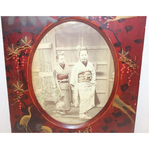 379 - Pair of early 20th century Japanese red lacquered photo frames with partially hand-coloured photogra... 