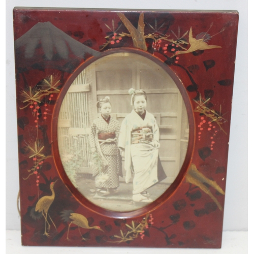 379 - Pair of early 20th century Japanese red lacquered photo frames with partially hand-coloured photogra... 