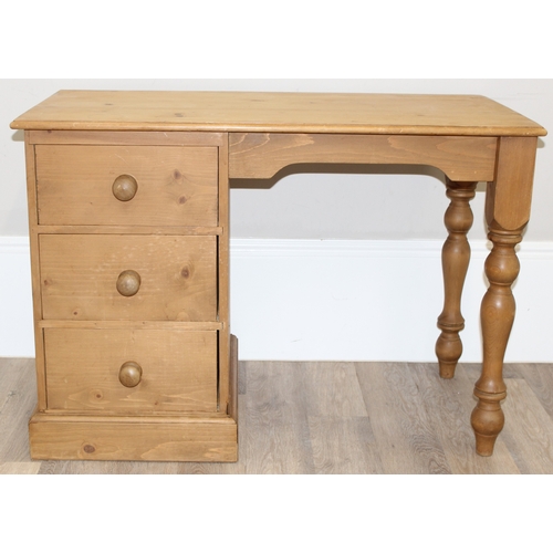 79 - A modern stripped pine desk with 3 drawers, approx 110cm wide x 57cm deep x 77cm tall