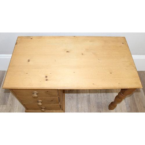 79 - A modern stripped pine desk with 3 drawers, approx 110cm wide x 57cm deep x 77cm tall