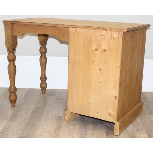 79 - A modern stripped pine desk with 3 drawers, approx 110cm wide x 57cm deep x 77cm tall