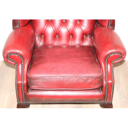 80 - An Ox-Blood red leather Chesterfield style wingback armchair by Wyvern, approx 82cm wide x 100cm tal... 