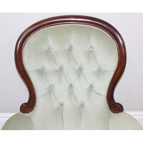 22 - A Victorian style mahogany framed button back nursing chair with brass castors and mint green uphols... 