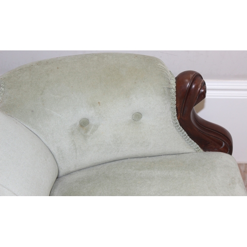 22 - A Victorian style mahogany framed button back nursing chair with brass castors and mint green uphols... 